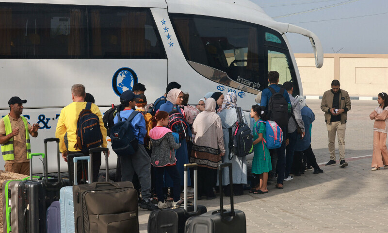 People wait on the Palestinian side of the Rafah border crossing with Egypt in the southern Gaza Strip on November 13, 2023. &mdash; AFP