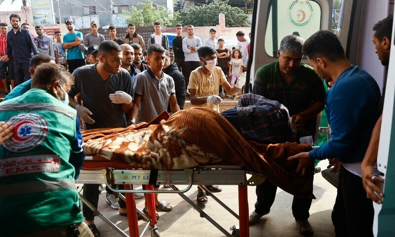 A Palestinian man wounded in an Israeli strike is rushed into an ambulance in Khan Younis in the southern Gaza Strip. &mdash; Reuters