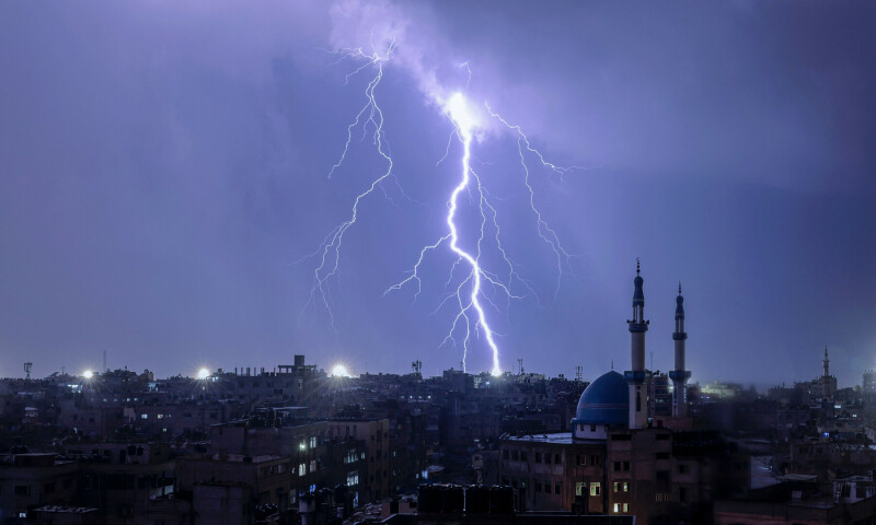  Lightening illuminates the sky during a storm over Rafah in the southern Gaza Strip on Nov 14, 2023. &mdash; AFP 
