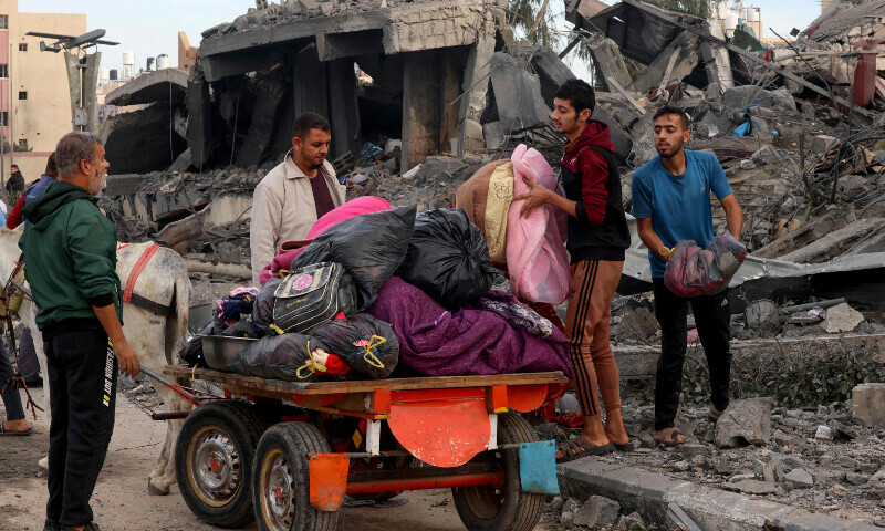 Palestinians recover items from the rubble of a building following Israeli strikes in Rafah in the southern Gaza Strip on November 22, 2023. &mdash; AFP