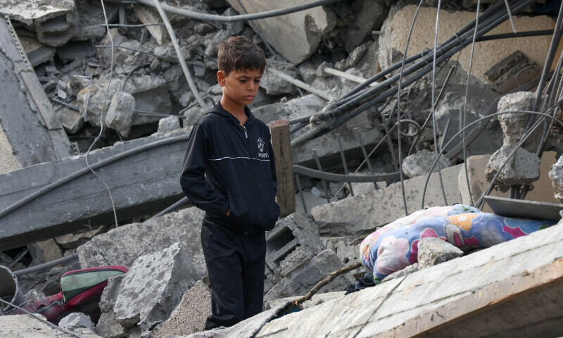 A Palestinian boy stands amidst the rubble of a building following Israeli strikes in Rafah in the southern Gaza Strip on November 22, 2023. &mdash; AFP