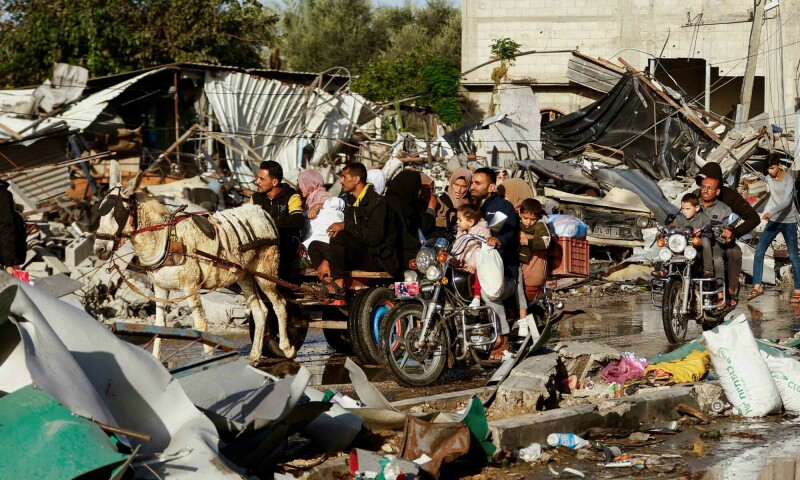In pictures: Gazans fill streets heading home on 1st day of temporary truce