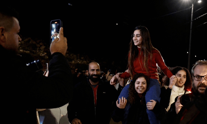 Newly released Palestinian prisoner Rouba Assi is carried by supporters during a welcome ceremony for prisoners freed from Israeli jails during a welcome ceremony in Ramallah in the occupied West Bank on Nov 28, 2023. &mdash; AFP 