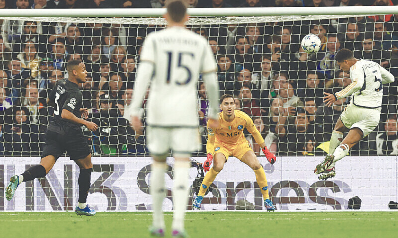 MADRID: Real Madrid’s Jude Bellingham heads to score past Napoli goalkeeper Alex Meret during their Group ‘C’ match at the Santiago Bernabeu Stadium.—AFP