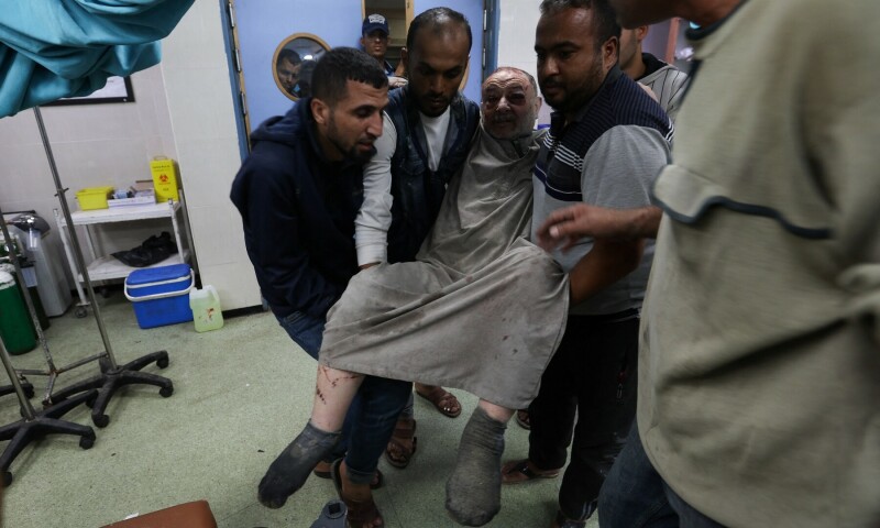 A wounded Palestinian is rushed into Nasser hospital following Israeli strikes on December 4, 2023. &mdash; Reuters