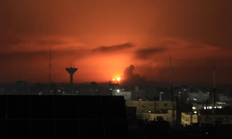  A picture taken from Rafah, on the southern Gaza Srip, shows smoke billowing over buildings following Israeli bombardment on Dec 4, 2023. &mdash; AFP