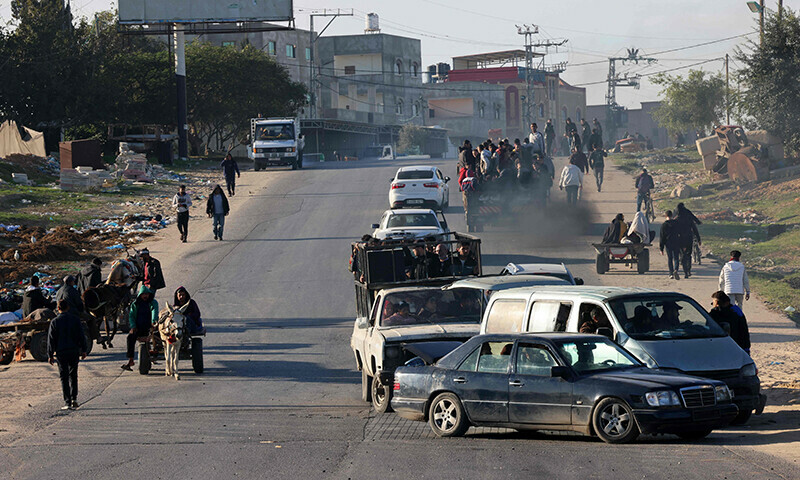 Palestinians flee Khan Younis in southern Gaza Strip further south toward Rafah, along the Salah Al-Din road, on December 10, 2023.&mdash;AFP