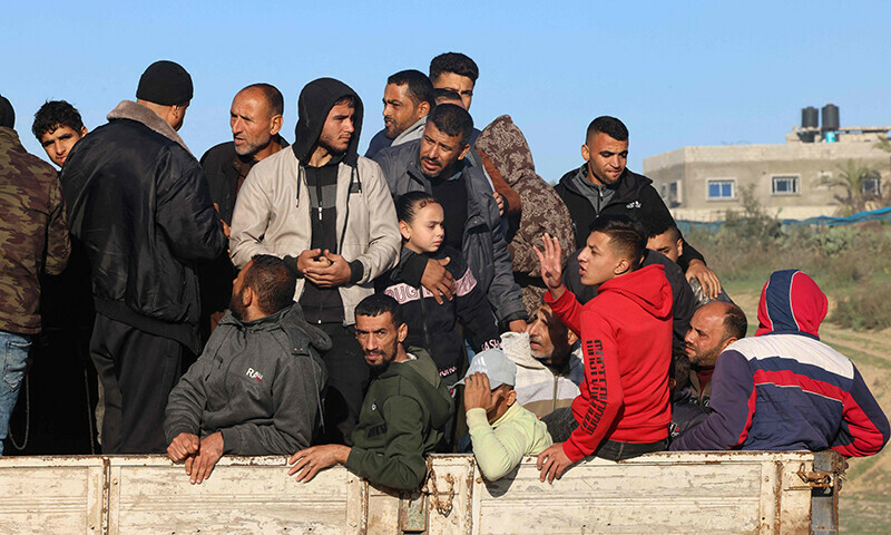 Palestinians flee Khan Younis in southern Gaza Strip further south toward Rafah, along the Salah Al-Din road, on December 10, 2023.&mdash;AFP