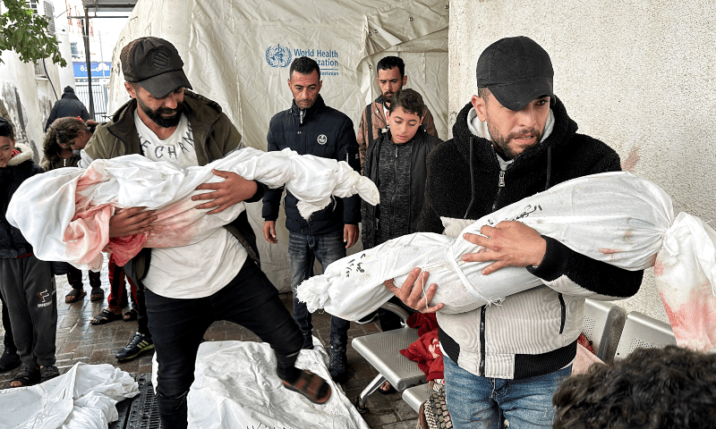  Mourners carry the bodies of Palestinian children killed in Israeli strikes on houses, at a hospital in Rafah, in the southern Gaza Strip on Dec 13, 2023. 
