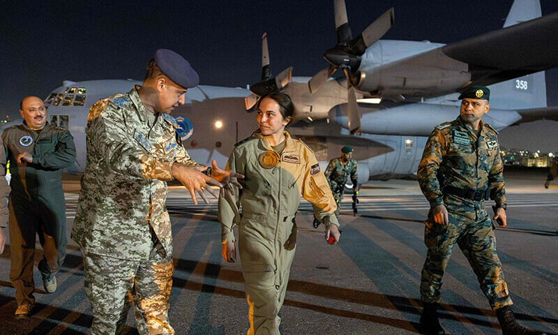 Princess Salma of Jordan (C), daughter of King Abdullah II and Queen Rania, walks with other military officers at Marka military airport after participating in the fifth Jordanian medical airdrop to Gaza. &mdash; AFP