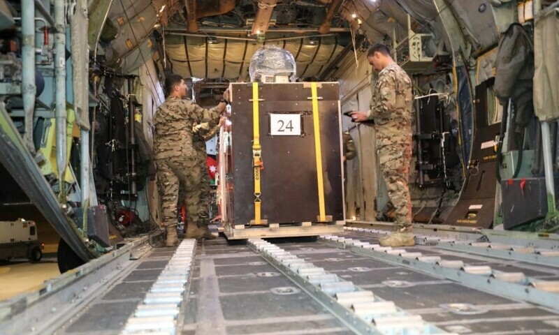 A picture released on December 24, 2023 by the Jordanian Armed Forces website shows members of the Jordanian military load what it said to be humanitarian aid into a plane to be airdropped to a church in Gaza on Christmas Eve. &mdash; Reuters