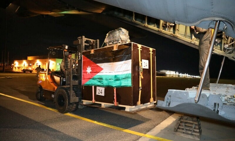 A picture released on December 24, 2023 by the Jordanian Armed Forces website shows members of the Jordanian military load what it said to be humanitarian aid into a plane to be airdropped to a church in Gaza on Christmas Eve. &mdash; Reuters