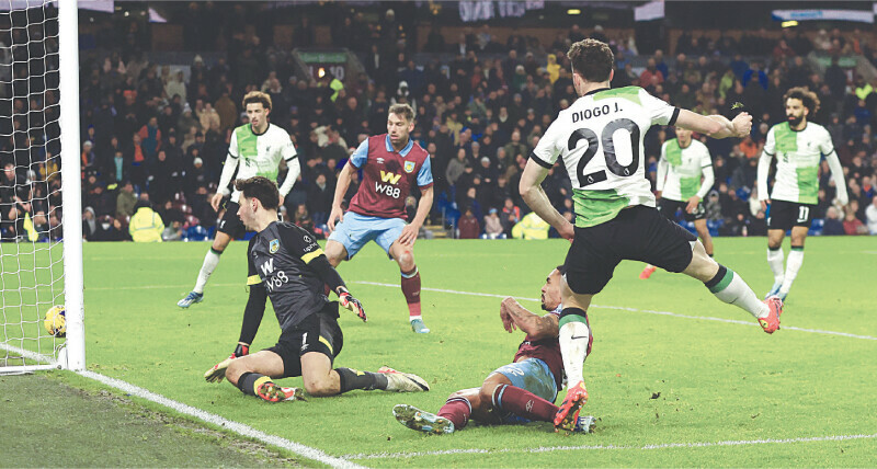 BURNLEY: Liverpool’s Diogo Jota (R) scores past Burnley goalkeeper James Trafford during their match at Turf Moor on Wednesday.—Reuters