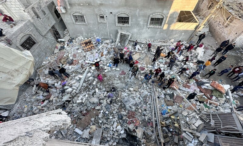 Palestinians gather at the site of an Israeli strike on a house in Rafah in the southern Gaza Strip, December 29. &mdash; Reuters
