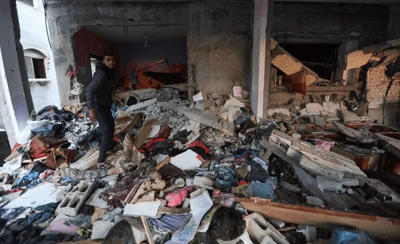 A Palestinian man inspects a house damaged in an Israeli strike in Rafah in the southern Gaza Strip, on January 5, 2024. &mdash; Reuters