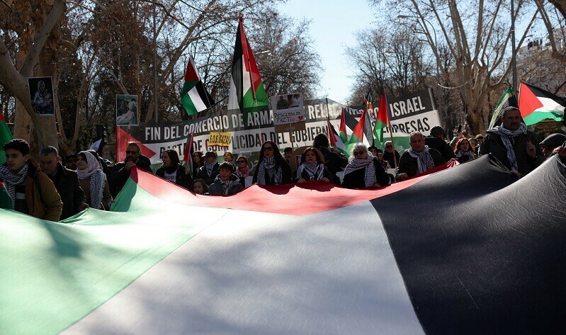 People hold a large Palestinian flag during a protest in Madrid, Spain, January 20, 2024. &mdash; Reuters