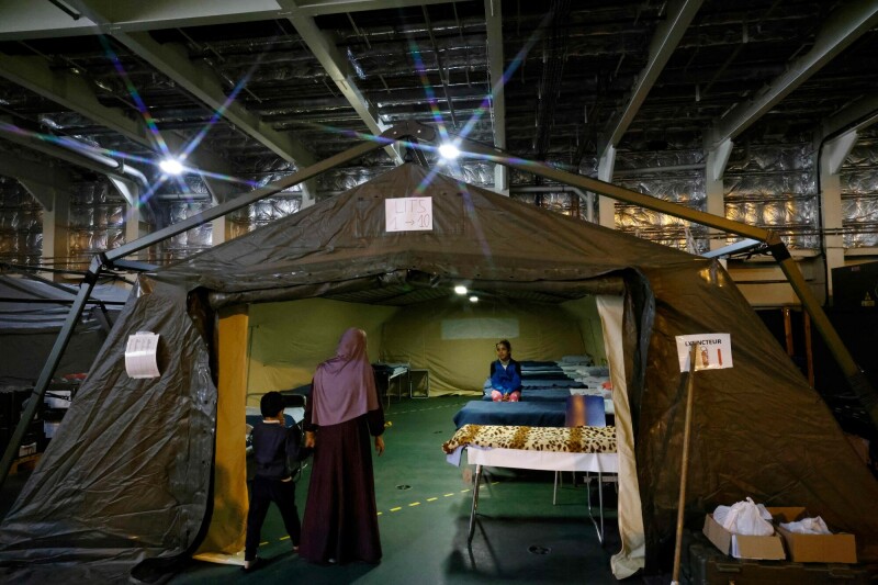 A Palestinian child sits on a bed under a tent onboard the French LHD Dixmude military ship, which serves as a hospital to treat wounded Palestinians, as it docks at the Egyptian port of Al-Arish on January 21. — AFP
