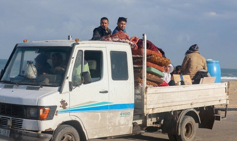 Palestinians arrive from Khan Yunis in a pick-up truck loaded with their belongings, to a makeshift tent camp for displaced people in Rafah on Jan 24. &mdash; AFP 