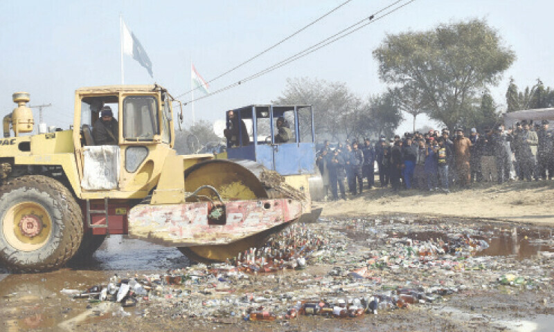 LAHORE: Seized bottles of liquor being destroyed on the International Customs Day. — Online