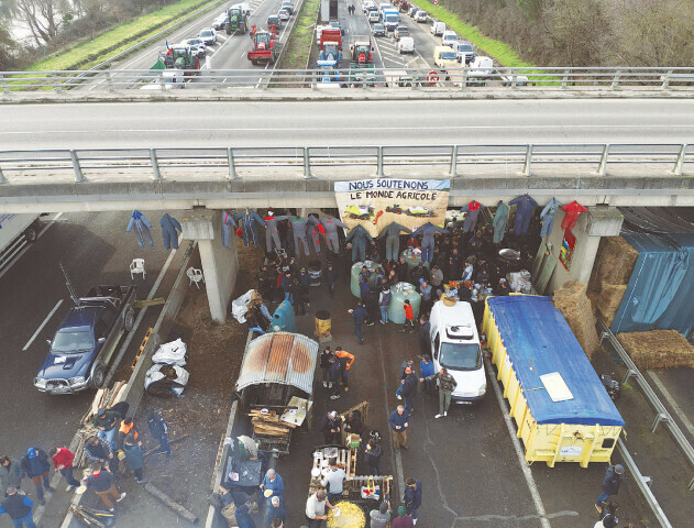 FRENCH farmers block a highway in Carbonne on Friday with their tractors to protest over price pressures, taxes and green regulation, grievances shared by farmers across Europe.—Reuters