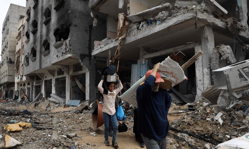 Palestinians carry some of their belongings on a donkey-pulled cart as they flee Khan YOunis in the southern Gaza Strip on March 7, 2024. — AFP