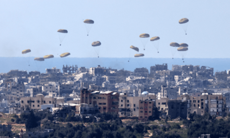This picture taken from Israel’s southern border with the Gaza Strip shows humanitarian aid being airdropped over the Palestinian territory on March 10, 2024. — AFP