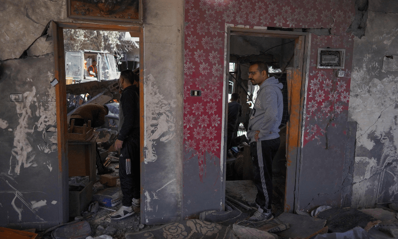  Palestinians inspect a damaged house following overnight Israeli bombardment at the Nuseirat refugee camp in the central Gaza Strip on March 20, 2024. &mdash; AFP 