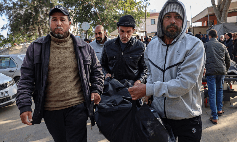  Palestinians carry the body of a relative killed in an Israeli bombardment, to the morgue of the European hospital in Khan Younis in the southern Gaza Strip on March 23, 2024. &mdash; AFP 