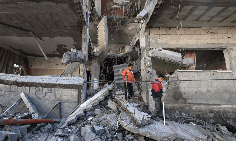  Palestinians inspect the damage to a building after overnight Israeli bombardment in Rafah in the southern Gaza Strip on March 25, 2024. &mdash; AFP 