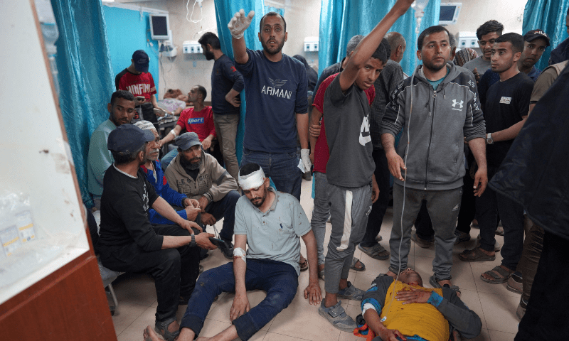  Injured Palestinian men lie on the floor at the Al-Aqsa Martyrs Hospital in Deir al-Balah in the central Gaza Strip, following Israel bombardment on March 31. &mdash; AFP 