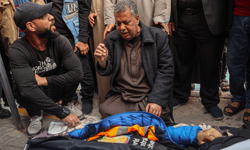  Relatives and friends mourn by the body of Saif Abu Taha, a WCK staff member who was killed in a Israeli strike a day earlier, during his funeral in Rafah in the southern Gaza Strip on April 2. &mdash; AFP 