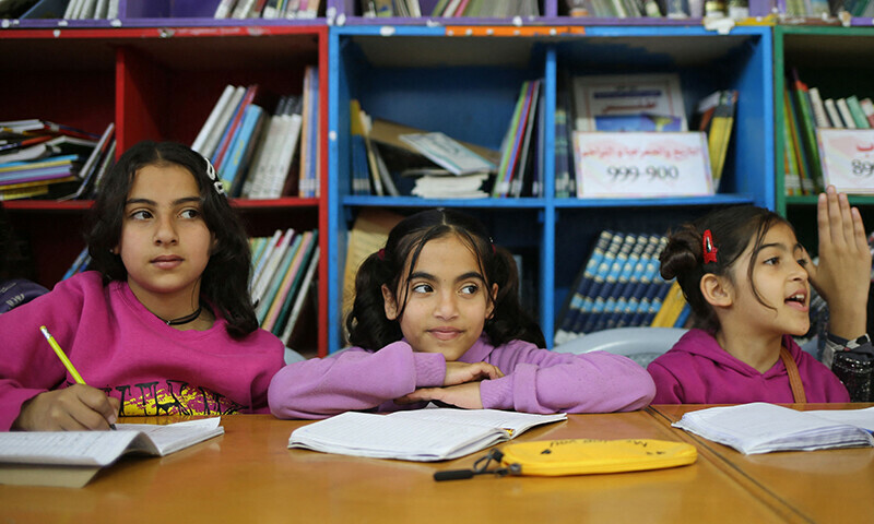 Displaced Palestinian children attend an English class in the library of the school housing displaced Gazans, in Rafah in the southern Gaza Strip on March 4, 2024.&mdash;AFP