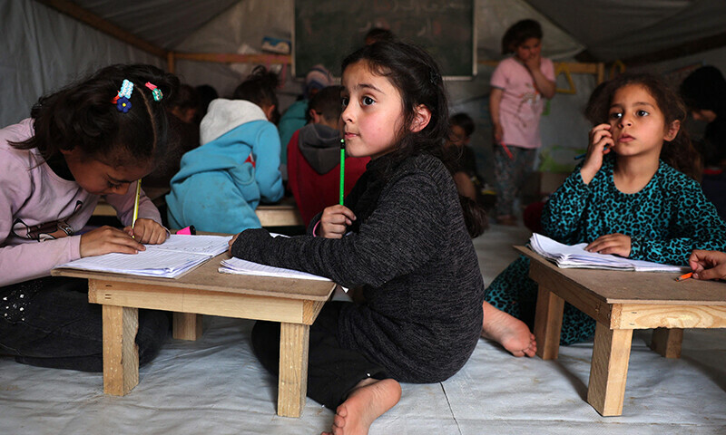Children attend class at a makeshift classroom in a camp for displaced Palestinians in Rafah, in the southern Gaza Strip on March 27, 2024.&mdash;AFP