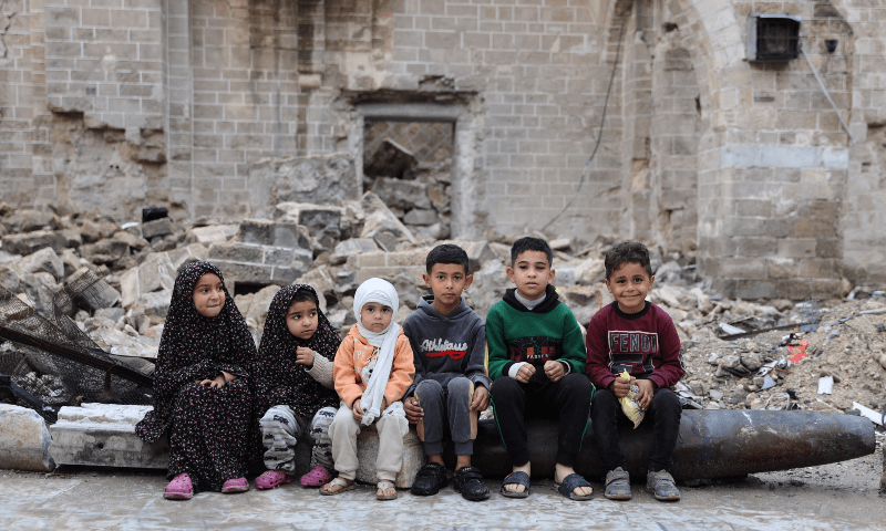  Palestinian children pose for a picture on April 10 in the courtyard of Gaza City&rsquo;s historic Omari Mosque, which has been heavily damaged in Israeli bombardment. &mdash; AFP 