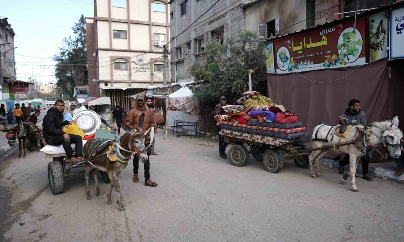 Palestinians gather belongings as people fleeing conflict leave their homes, in the Nuseirat refugee camp in central Gaza on April 12. &mdash; AFP
