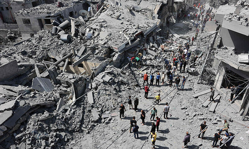 Palestinians inspect the debris after the Israeli bombardment of the Al-Daraj neighbourhood in Gaza City on April 22. &mdash; AFP