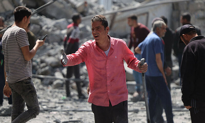 Palestinians inspect the debris after the Israeli bombardment of Al-Daraj neighbourhood in Gaza City on April 22. &mdash; AFP
