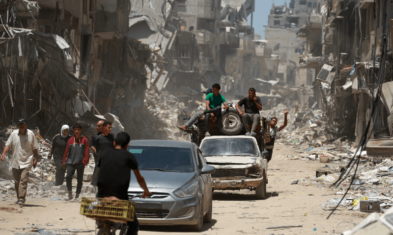  Displaced Palestinians arrive in vehicles carrying their belongings to set up shelter after returning to Khan Younis in the southern Gaza Strip on May 9. &mdash; AFP 
