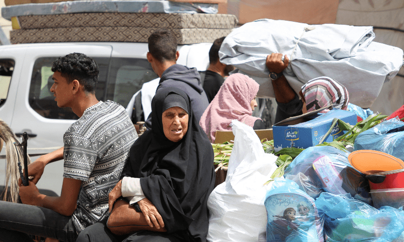  A woman sits next to belongings, as Palestinians prepare to evacuate, after Israeli forces launched a ground and air operation in the eastern part of Rafah in the southern Gaza Strip on May 11. &mdash; Reuters 