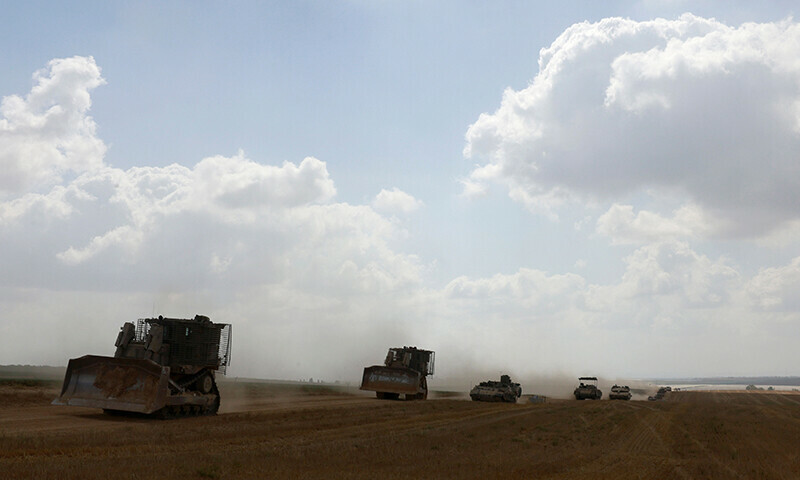 Israeli military vehicles roll near the border with the Gaza Strip on May 12, 2024. — AFP