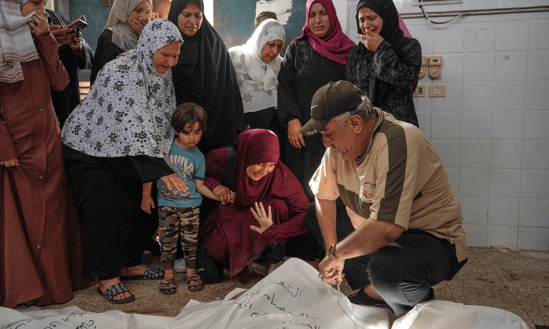 Palestinian women react as they identify victims at the Al-Aqsa Martyrs Hospital in Deir al-Balah following Israeli bombardment overnight on May 23, 2024. — AFP