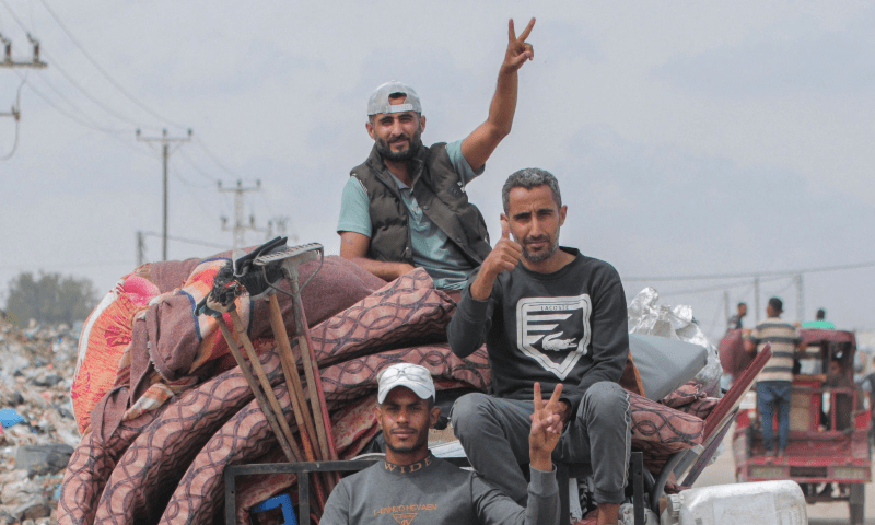 Palestinians fleeing unsafe areas in Rafah arrive with their belongings in Khan Younis, further north in the southern Gaza Strip, following renewed Israeli strikes on May 28, 2024. — AFP