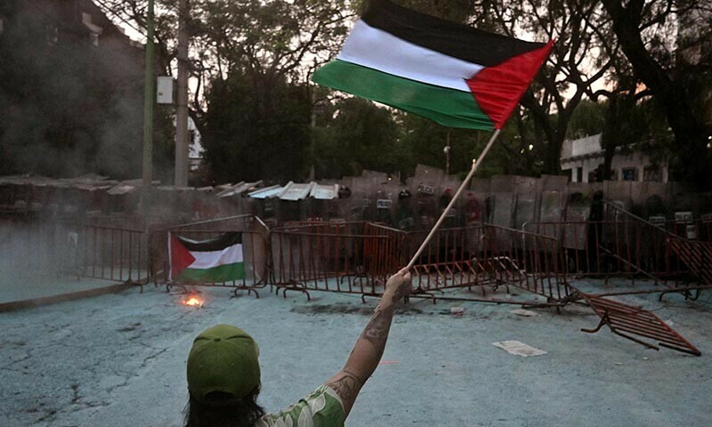 A woman waves a Palestinian flag during a pro-Palestinian rally called “Urgent action for Rafah” in front of the Israeli embassy in Mexico City on May 28. — AFP