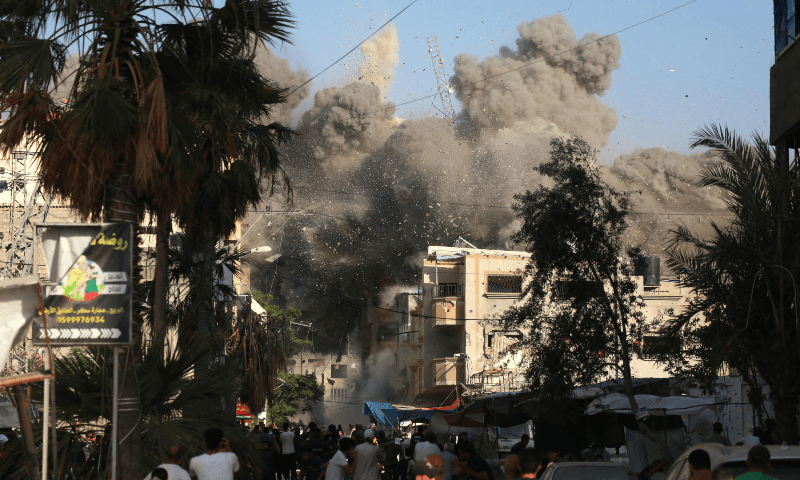 Dust and black smoke rises moments after an Israeli air strike targeted a residential building in the city of Bureij in the central Gaza Strip on June 3, 2024. — AFP