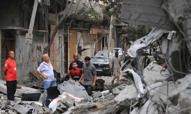  Palestinians inspect the damage and debris a day after an operation by the Israeli Special Forces in the Nuseirat camp, in the central Gaza Strip on June 9, 2024. &mdash; AFP 