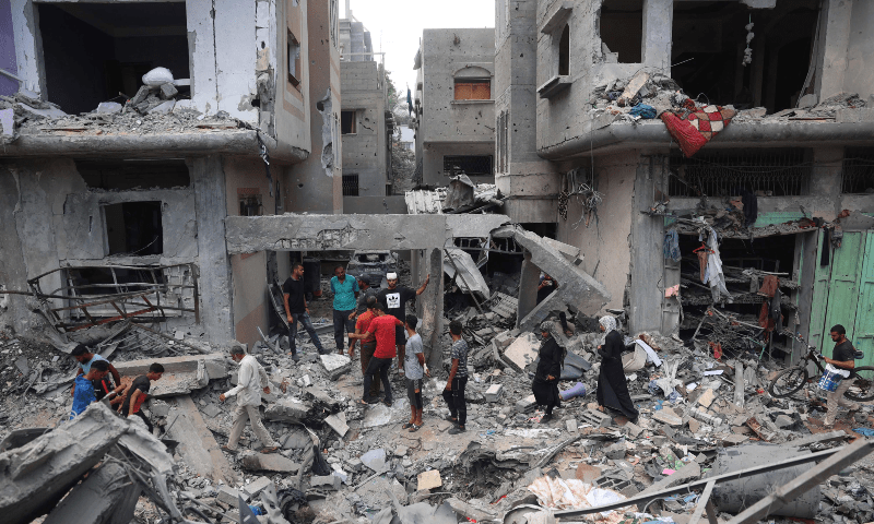  Palestinians inspect the damage and debris a day after an operation by the Israeli Special Forces in the Nuseirat camp, in the central Gaza Strip on June 9, 2024. &mdash; AFP 