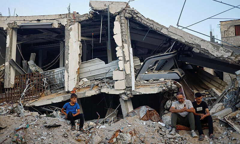 Palestinians hold Eidul Azha prayers by the ruins of Al-Rahma mosque in Khan Younis, in the southern Gaza Strip on June 16. &mdash; Reuters