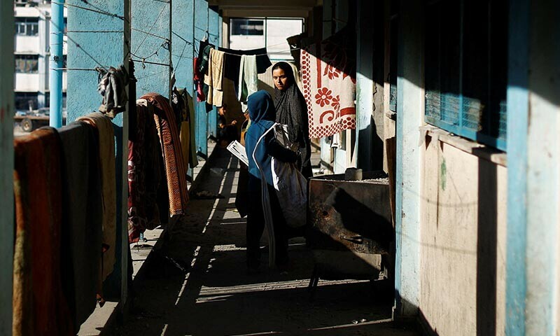 A Palestinian woman looks on as she stands in a ruined UNRWA school, after an air strike on a neighbouring house in Khan Younis on June 21. &mdash; Reuters