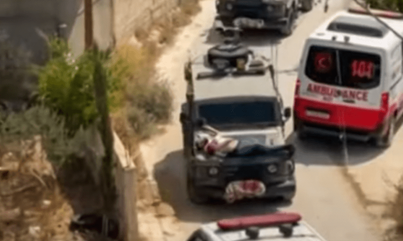An injured man is seen strapped to the hood of an Israeli armoured vehicle as it drives down the road in Jenin, occupied West Bank. &mdash; Screengrab via Al Jazeera