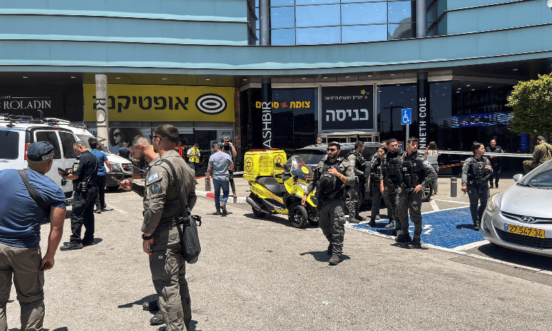  Israeli security officials gather outside a shopping mall following a stabbing attack in Karmiel, northern Israel on July 3 2024. &mdash; Reuters 